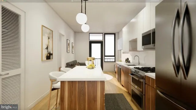 a kitchen with stainless steel appliances a sink stove microwave and refrigerator