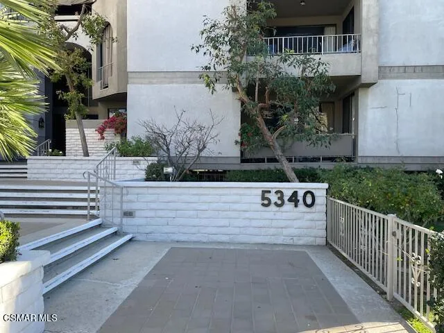 a view of entrance gate of the house and tree