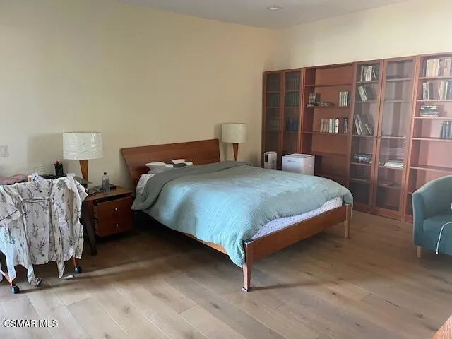 a bedroom with furniture and a flat screen tv