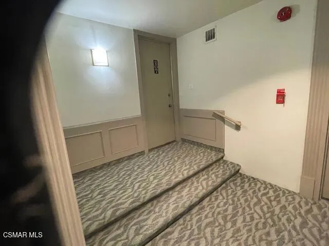 a view of a patio with a table and chairs under an umbrella