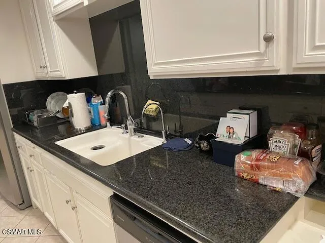 a kitchen with a sink a stove and cabinets