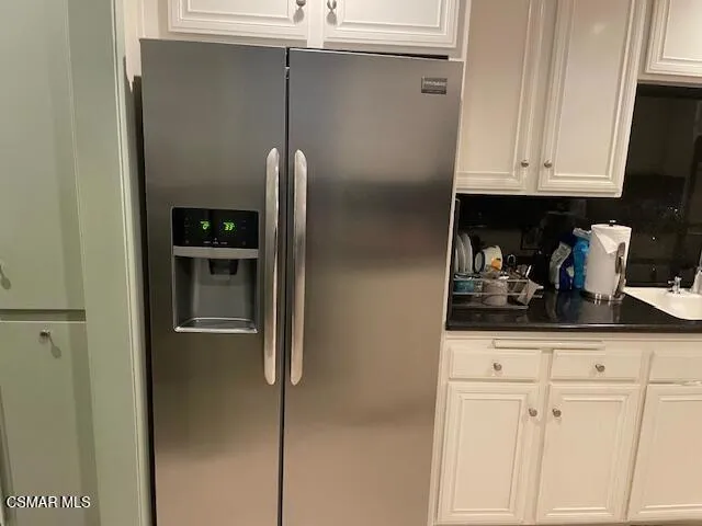 a kitchen with appliances and cabinets