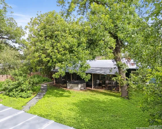 a view of an house with backyard space and sitting area