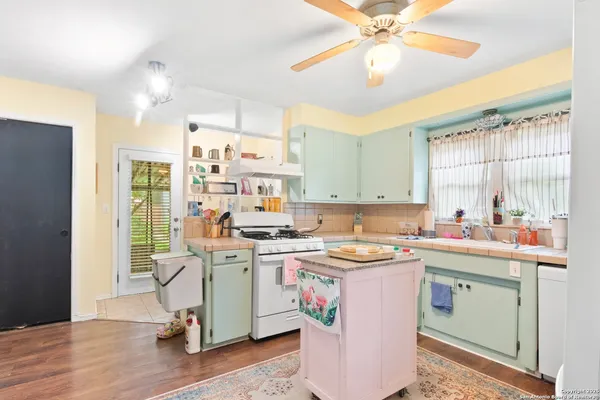 a kitchen with a stove a sink and a refrigerator