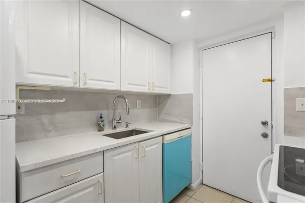 a kitchen with a sink and cabinets