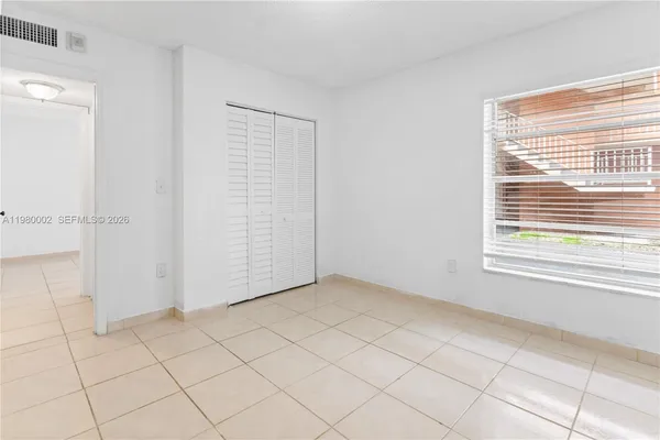 an empty room with white walls and tiles