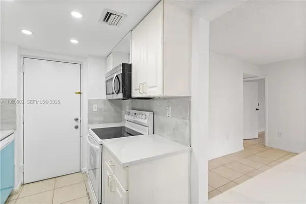 a kitchen with a sink and refrigerator