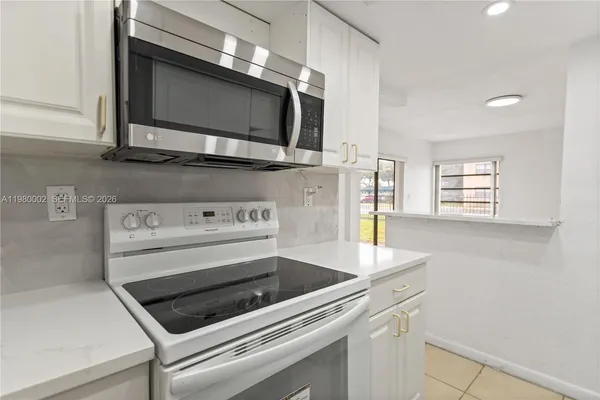 a kitchen with a stove and a microwave