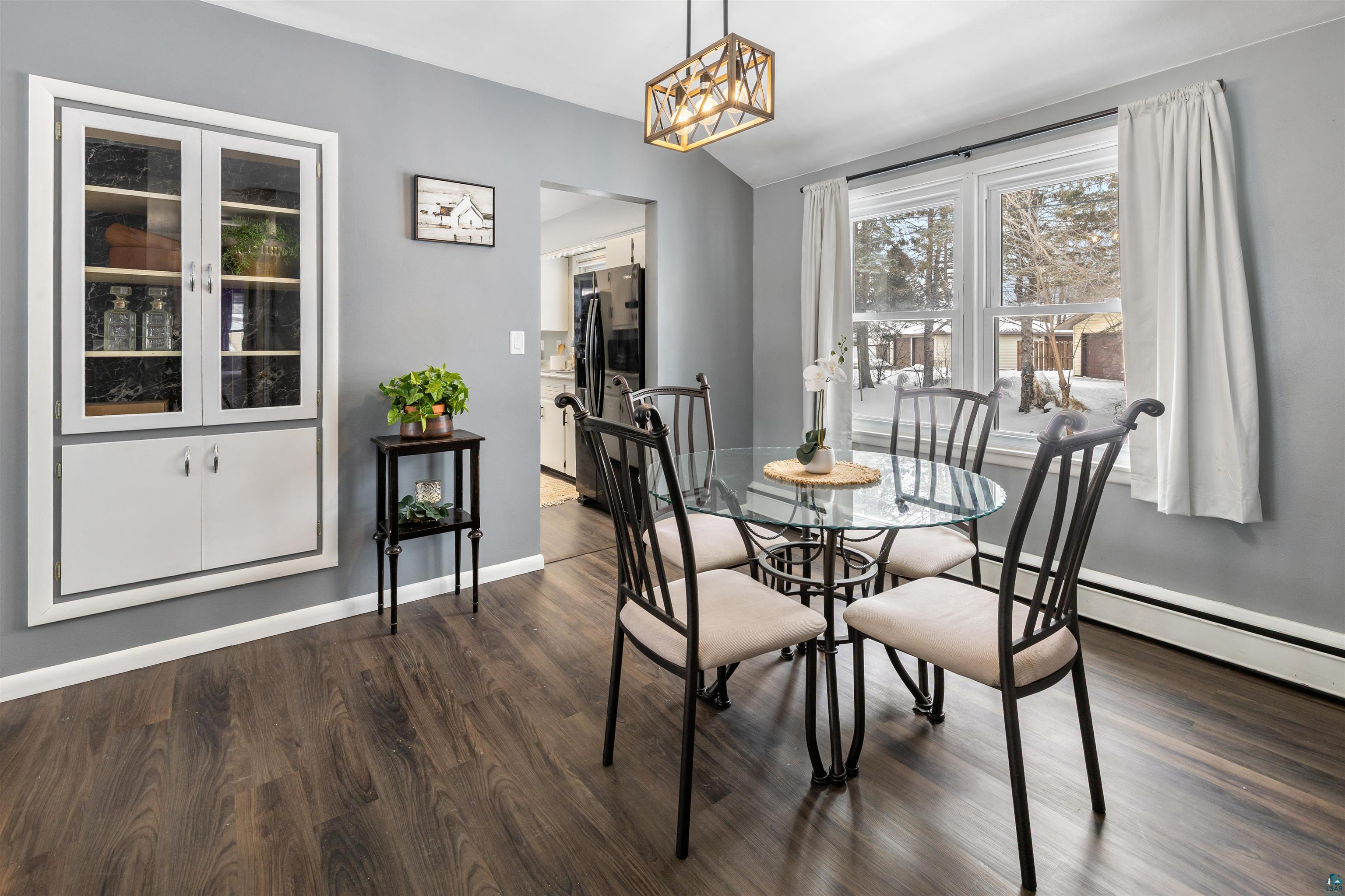 1101 13th Street South Virginia, MN 55792 - Photo 13 of 43 Dining room featuring built-in, dark laminate flooring and suspended lighting