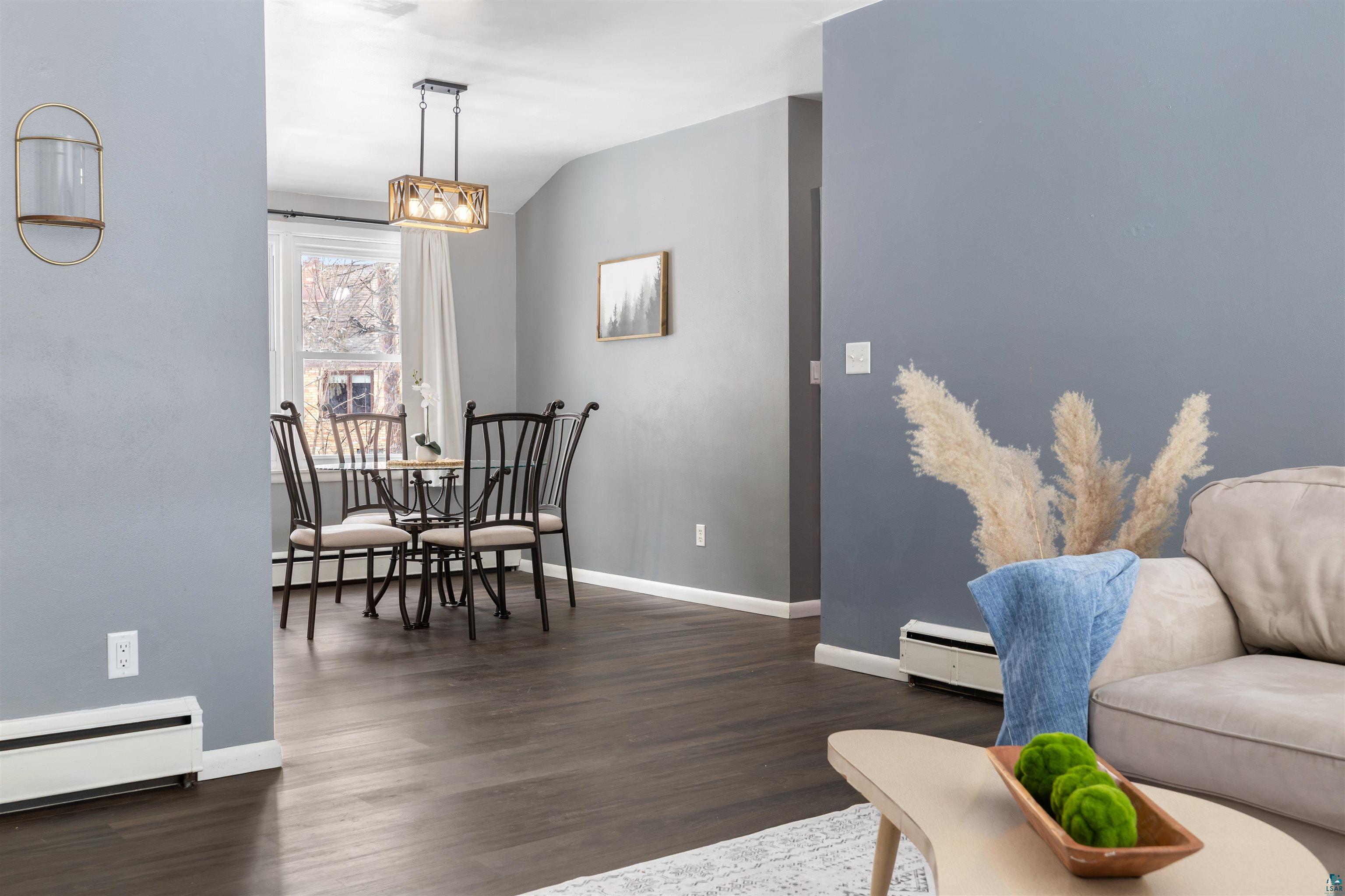 1101 13th Street South Virginia, MN 55792 - Photo 8 of 43 Living room view looking into dining area with dark laminate flooring