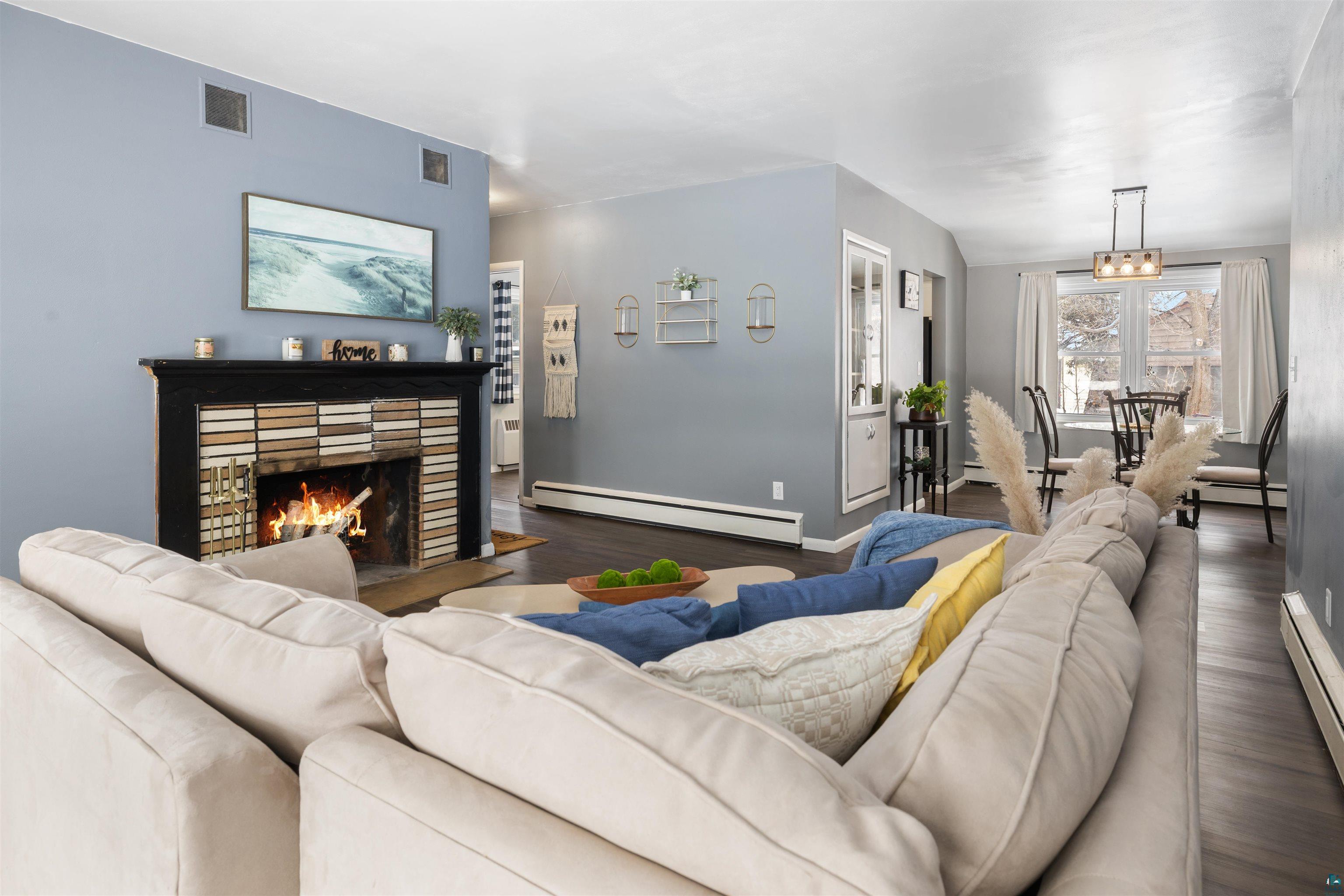 1101 13th Street South Virginia, MN 55792 - Photo 9 of 43 Living room with dark laminate flooring, and a wood burning fireplace