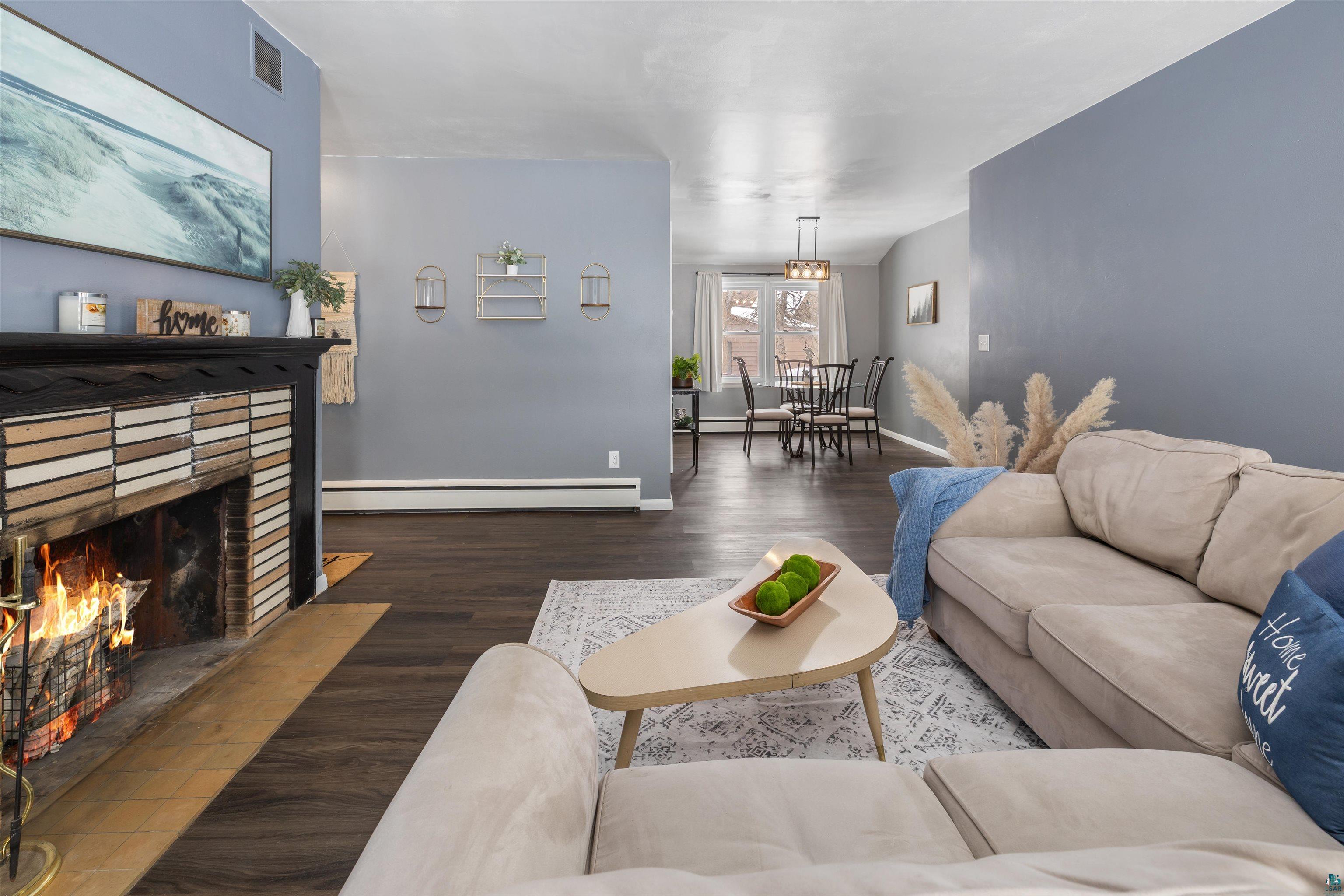 1101 13th Street South Virginia, MN 55792 - Photo 10 of 43 Living room featuring a wood burning fireplace and dark laminate flooring