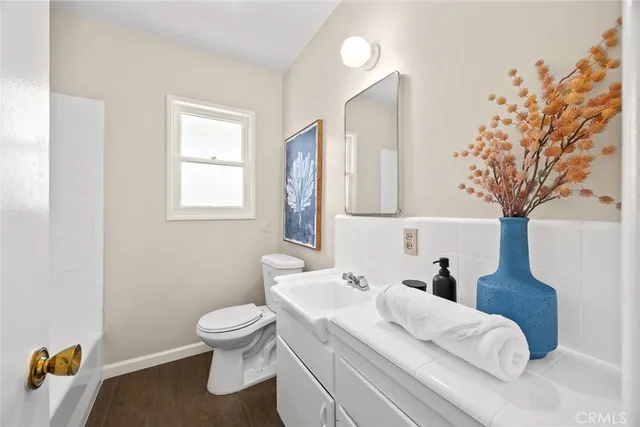 a bathroom with a toilet sink and mirror