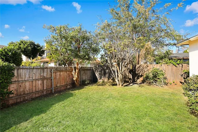an aerial view of a house with a garden and lake view