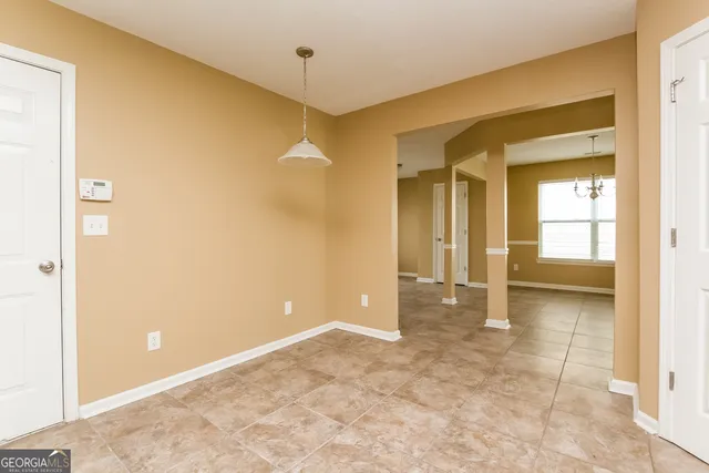 an empty room with a bathroom and a sink