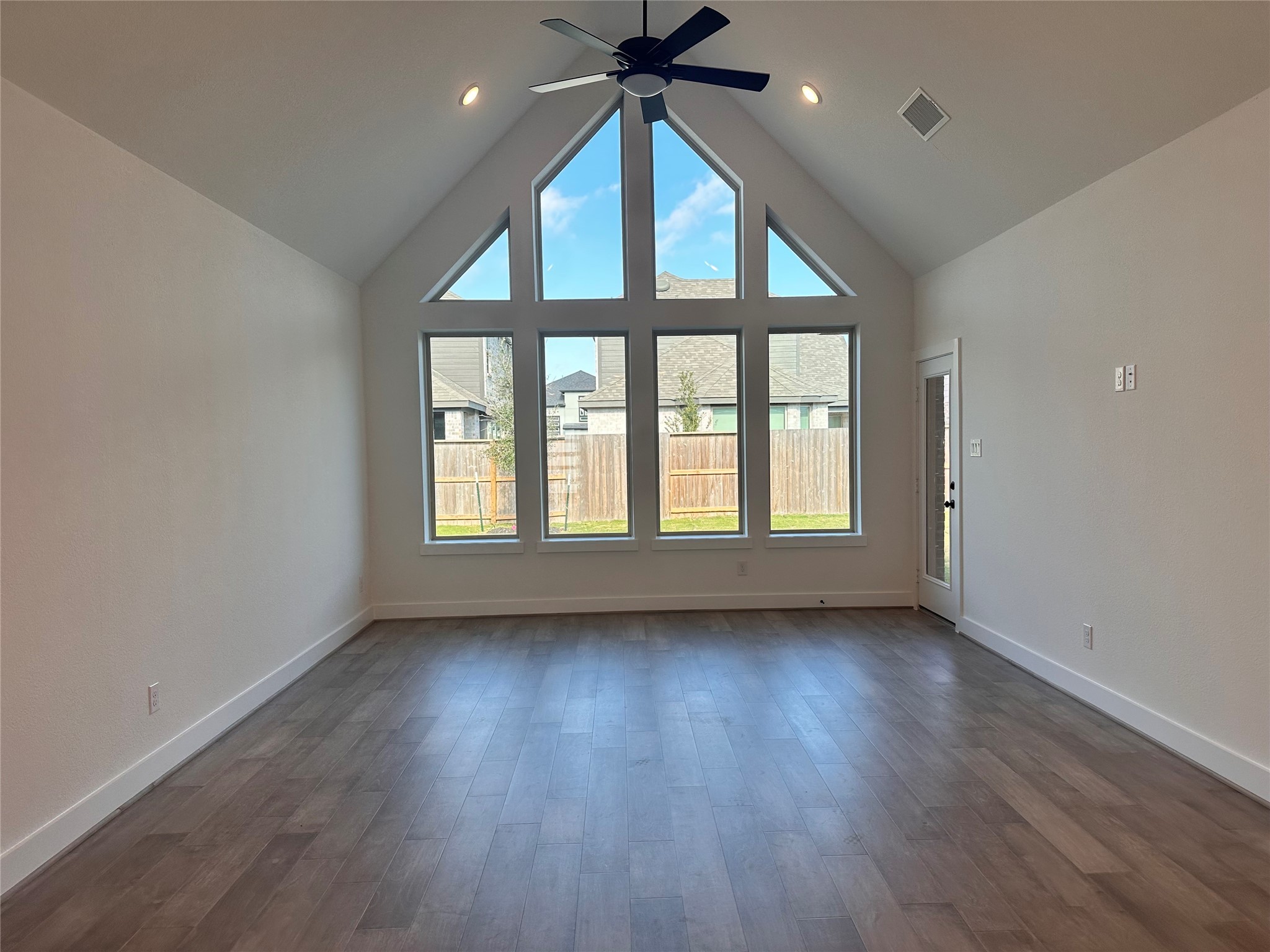 5219 Getty Lane Iowa Colony, TX 77578 - Photo 2 of 29 an empty room with wooden floor fan and windows