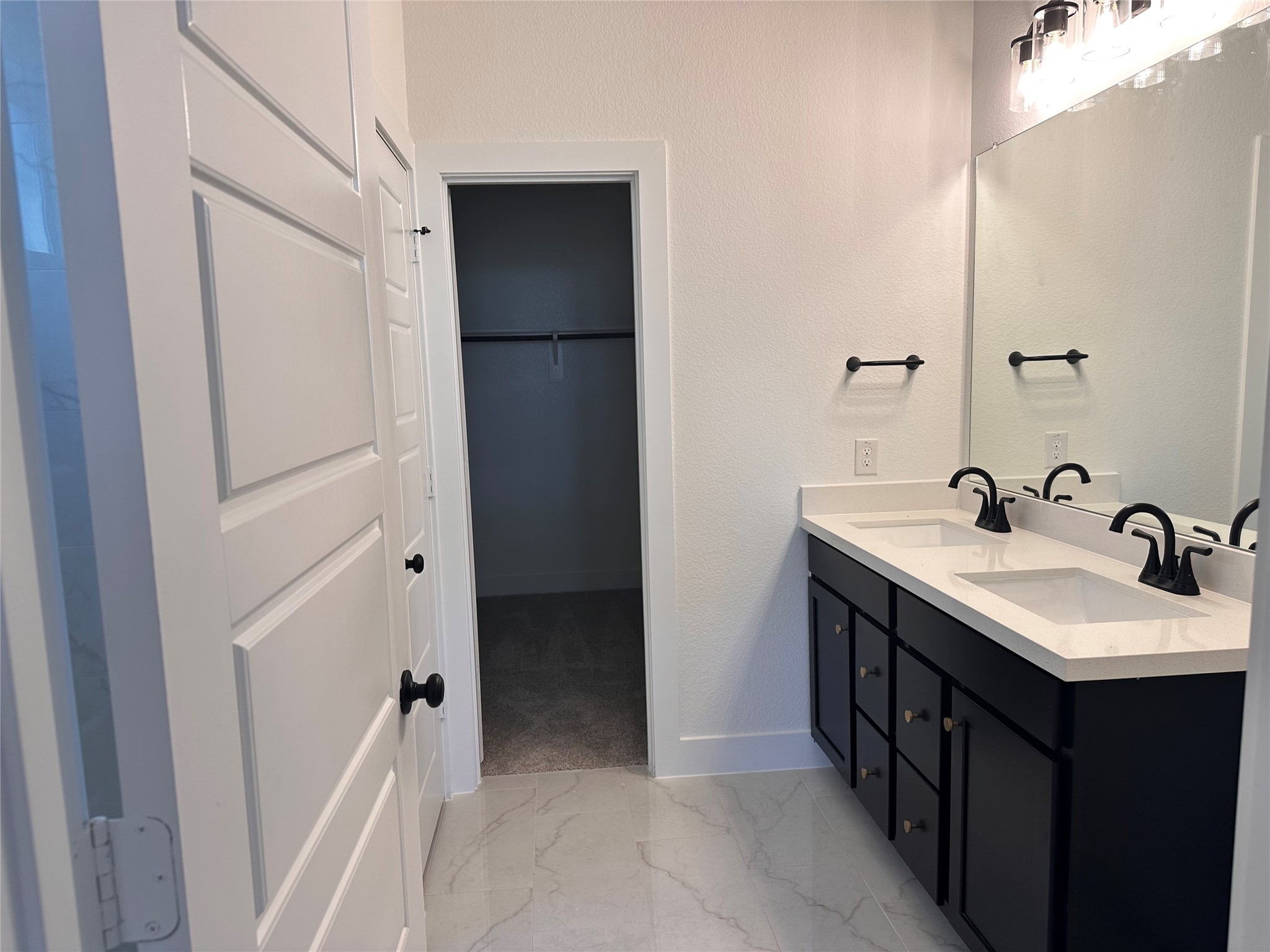 5219 Getty Lane Iowa Colony, TX 77578 - Photo 4 of 29 a bathroom with a double vanity sink and mirror