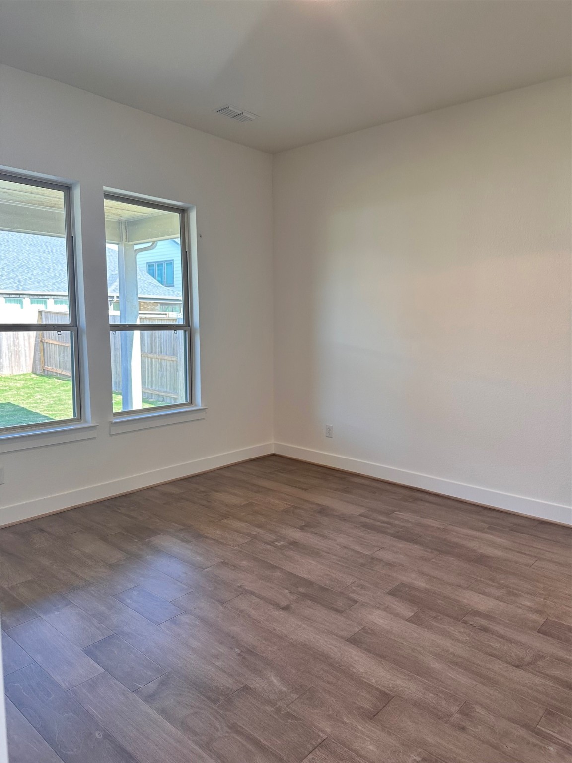 5219 Getty Lane Iowa Colony, TX 77578 - Photo 6 of 29 a view of an empty room with wooden floor and a window