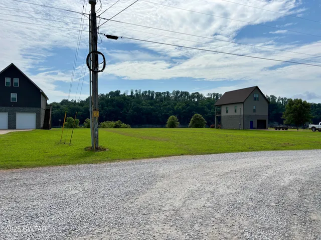 a view of a house with a big yard and potted plants