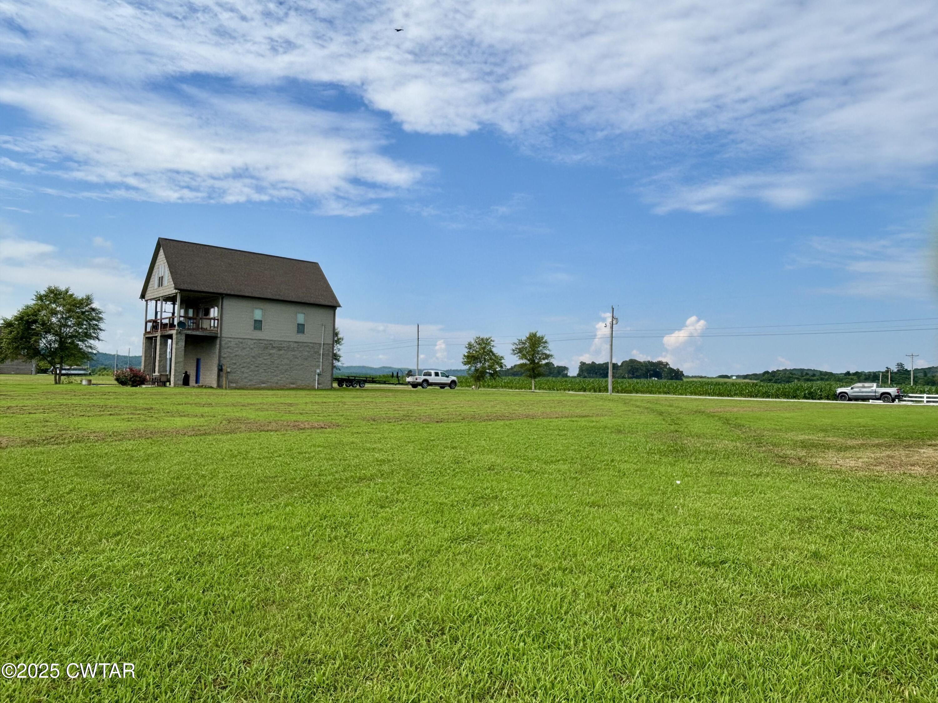 995 Hardin Bottom River Road Clifton, TN 38425 - Photo 4 of 8 a backyard of a house with lots of green space