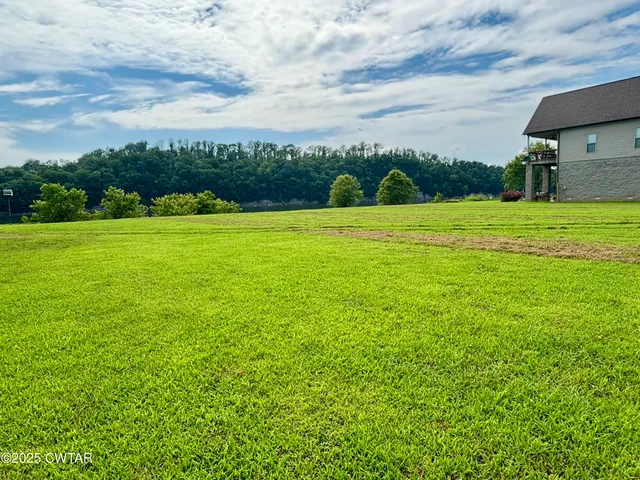 a view of a field of grass and a building