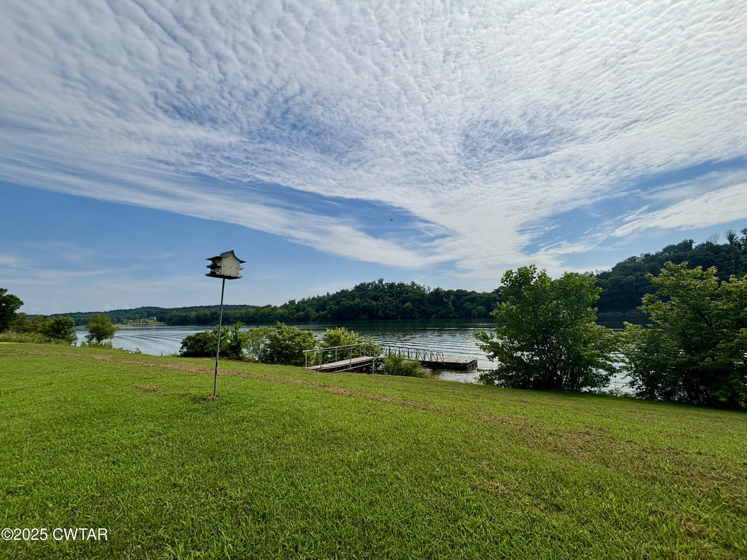 995 Hardin Bottom River Road Clifton, TN 38425 - Photo 6 of 8 a view of a lake with a big yard