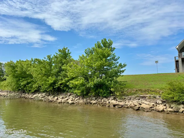 an aerial view of ocean with residential houses with outdoor space