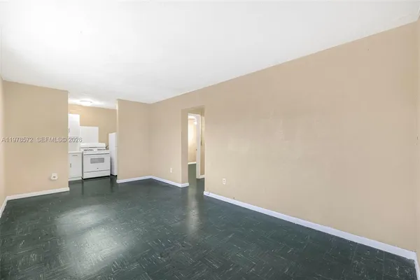 an empty room with a cabinet and mirrors