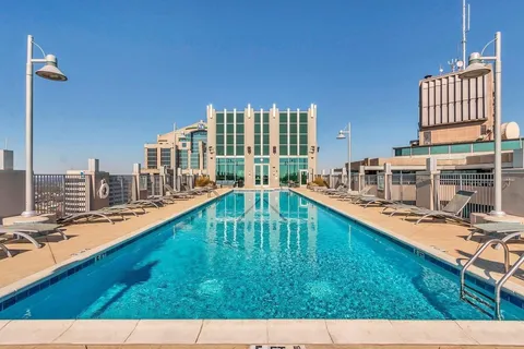 a swimming pool with outdoor seating and yard