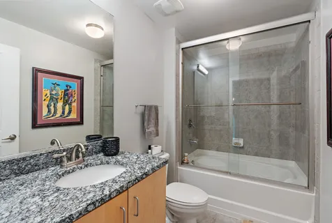 a view of a balcony with chairs and city view