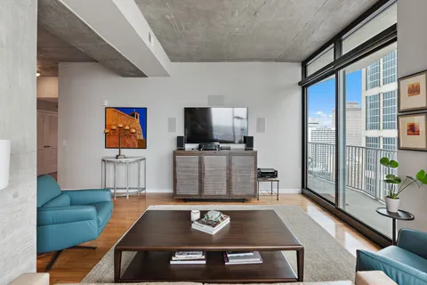 a living room with furniture and a floor to ceiling window