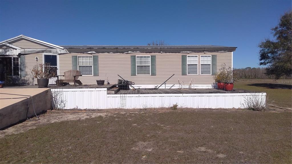 12051 Avon Park Cut Off Road Fort Meade, FL 33841 - Photo 1 of 10 a front view of a house with entertaining space