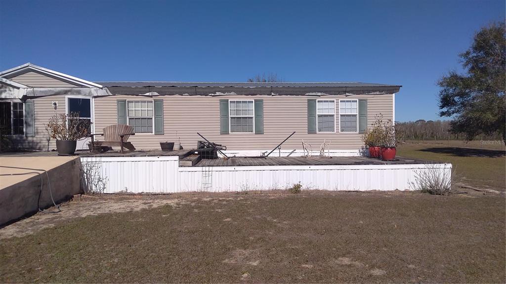 12051 Avon Park Cut Off Road Fort Meade, FL 33841 - Photo 2 of 10 a front view of a house with swimming pool