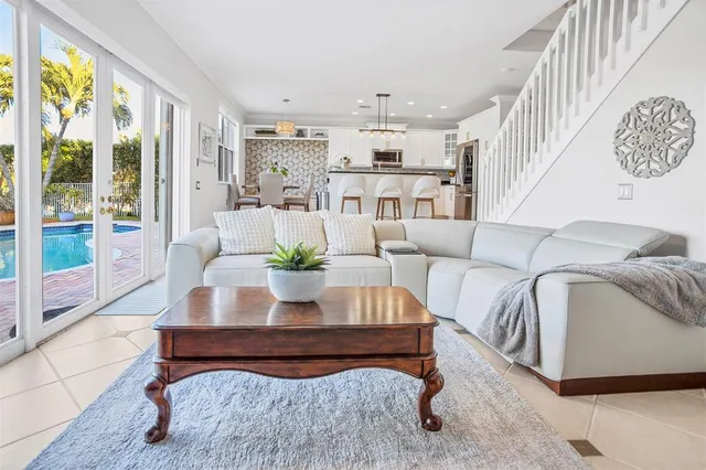 a living room with furniture and a potted plant