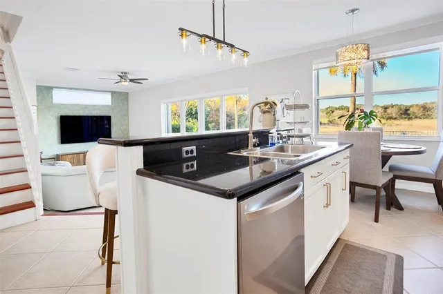 a kitchen with a sink appliances and a counter top space