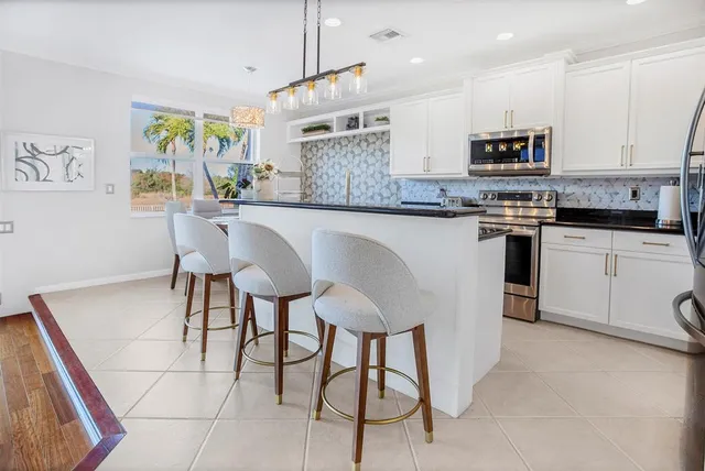a large kitchen with granite countertop lots of counter space and window