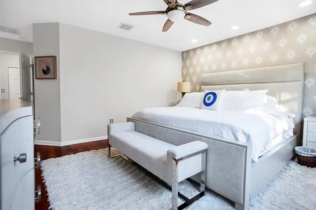 a bedroom with a bed and a chandelier