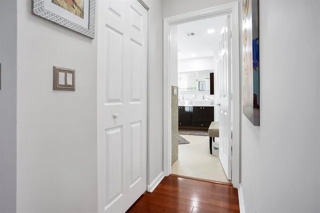 a view of a hallway view with wooden floor and staircase