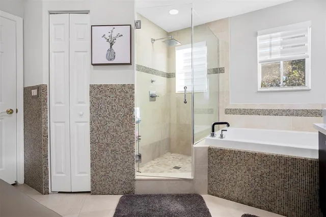 a bathroom with a bathtub shower and a sink