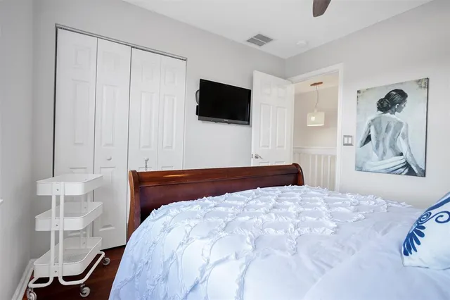 a bedroom with a bed and a flat screen tv