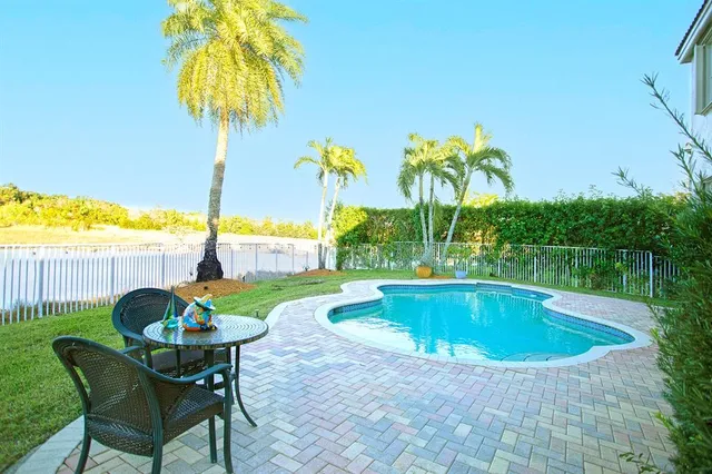 a view of swimming pool with a table and chairs