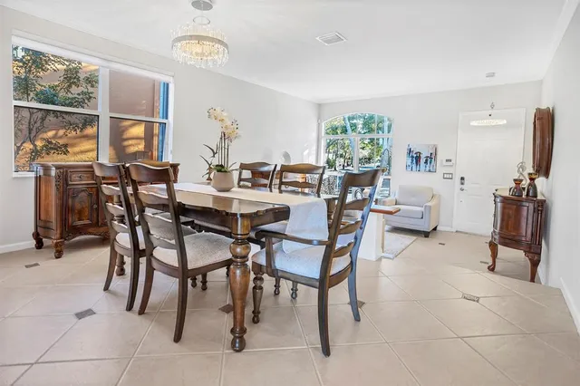 a view of a dining room with furniture and a potted plant