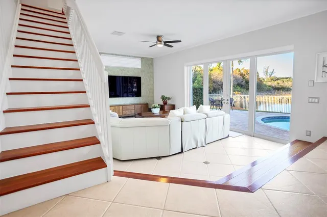 a living room with a balcony furniture and a flat screen tv