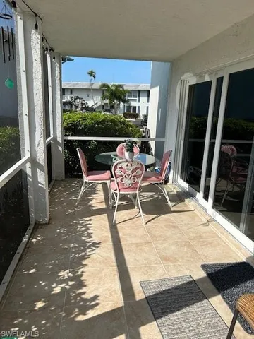 a view of a swimming pool with furniture