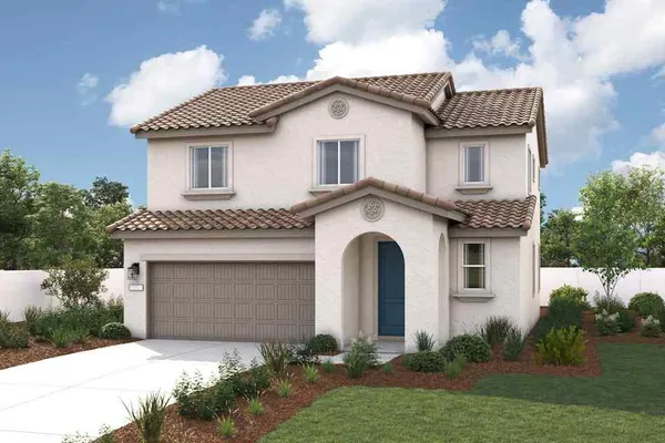 a front view of a house with a garden and plants