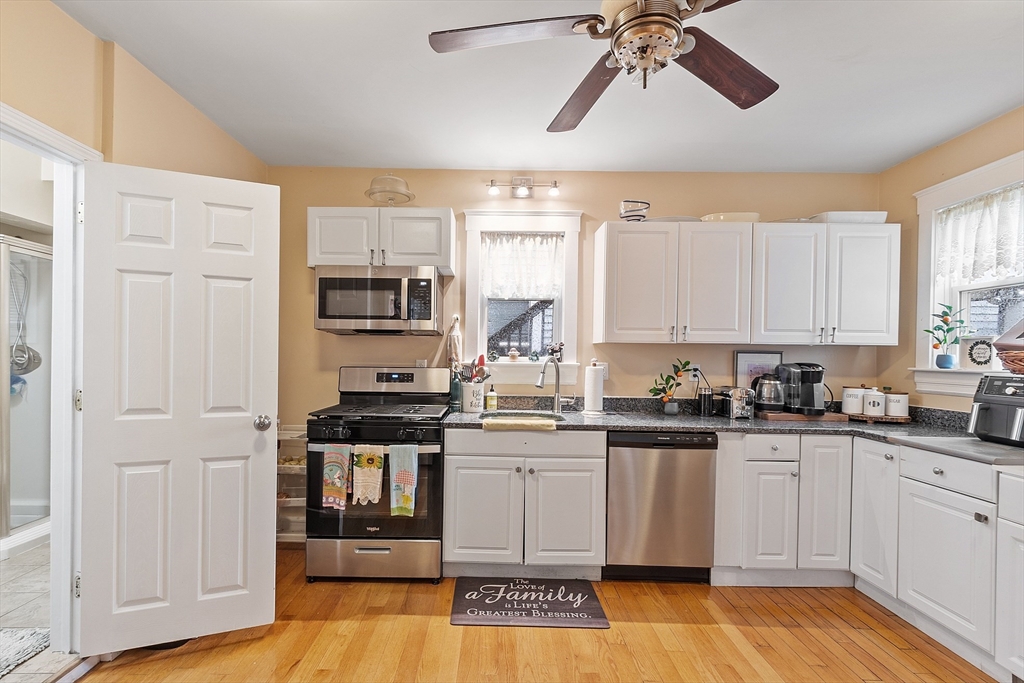 7 Washington Street Somerville, MA 02143 - Photo 11 of 27 a kitchen with stainless steel appliances granite countertop a stove a sink and white cabinets