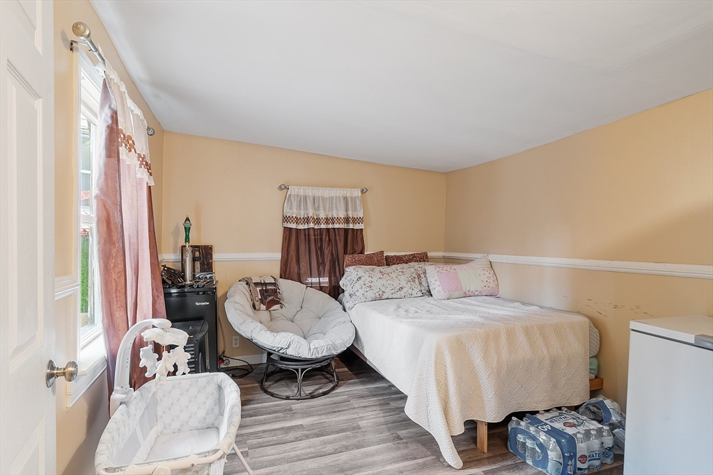 7 Washington Street Somerville, MA 02143 - Photo 14 of 27 a bedroom with furniture and a window