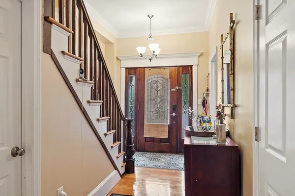 a view of entryway and hall with wooden floor