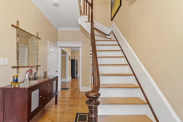 a view of entryway with stairs and wooden floor