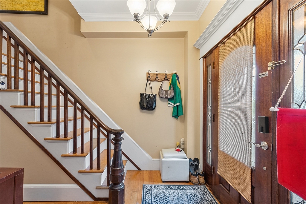 7 Washington Street Somerville, MA 02143 - Photo 18 of 27 a view of entryway with stairs and wooden floor